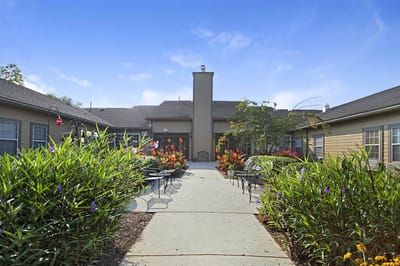Pathway through a colorful garden leading to a facility