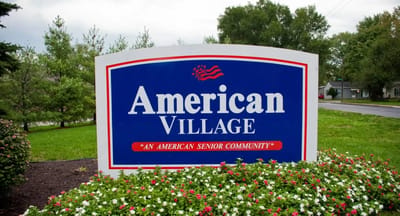 American Village facility logo on a sign