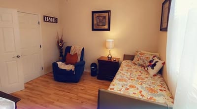 Cozy resident room with a chair and bed
