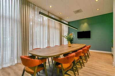 Interior dining area with a large table and modern decor