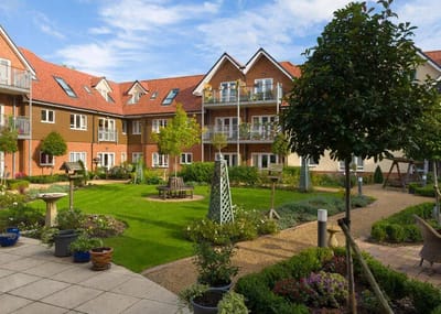 A well-maintained garden area with residential buildings