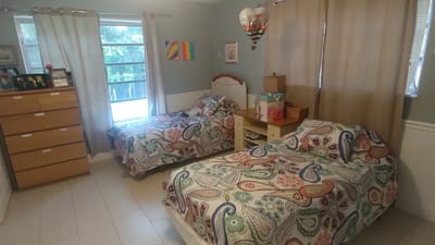 Cozy shared bedroom with two beds and natural light