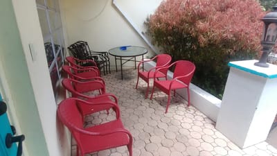 Outdoor seating area with red chairs and table