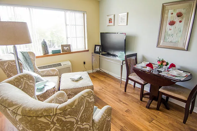 Cozy living area of a resident's room with a dining table