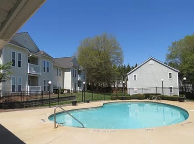 Outdoor pool area surrounded by buildings