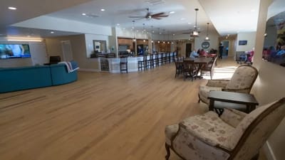 Bright, open common area with seating and residents