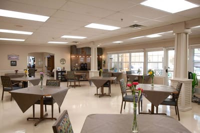 Bright dining area with tables and flowers