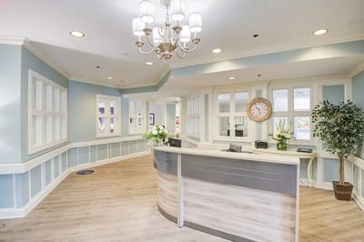 Bright interior lobby with reception desk and windows