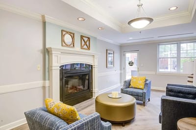 A cozy common area with seating and fireplace