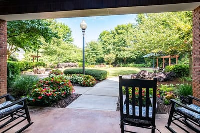 View of a landscaped garden with rocking chairs