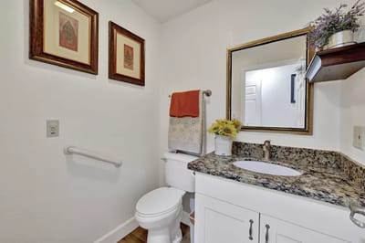 A well-lit bathroom with decorative elements