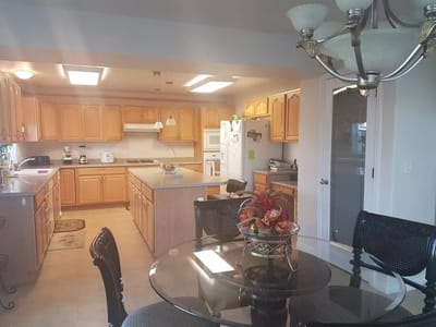 Bright kitchen area with wooden cabinets and dining table