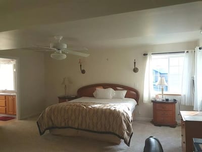 A well-furnished resident bedroom with a queen bed
