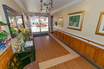 Brightly lit interior hallway with artwork
