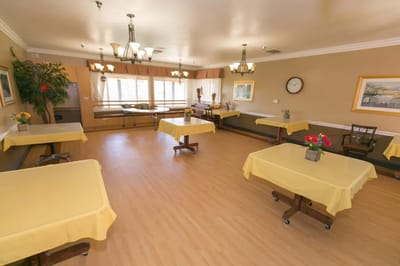 Bright activity room with tables and flowers