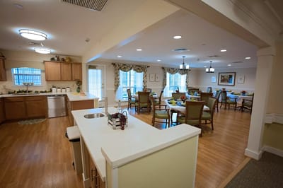 Dining area with tables and chairs set for residents