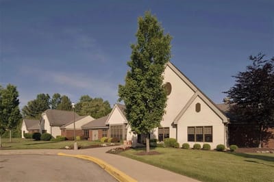 Exterior view of a senior living facility with landscaping