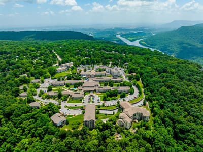 Aerial view of a senior living campus surrounded by greenery.