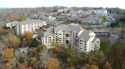 Aerial view of the senior living facility surrounded by fall foliage