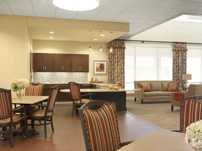 Bright common area with seating and kitchenette