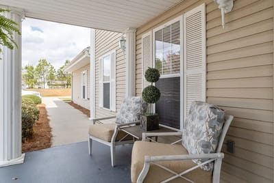 Cozy porch seating area with decorative plants