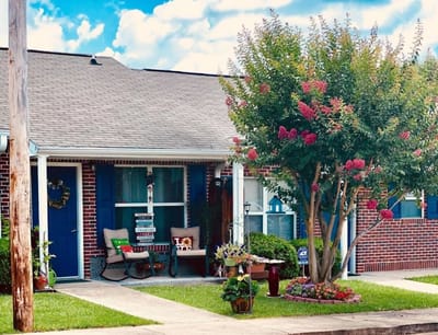 Exterior view of a retirement community entrance with flowers