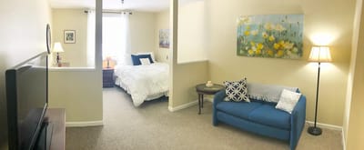 Interior view of a resident room with bed and sofa