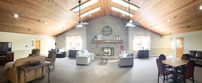 Bright common area with comfortable seating and a fireplace