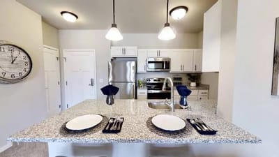 Modern kitchen in a senior living unit with plates set on the counter