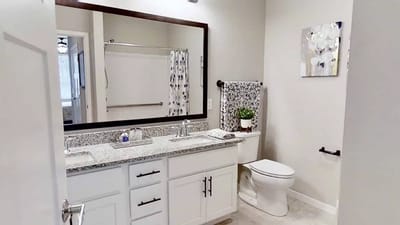 Modern bathroom with granite countertops and spacious layout