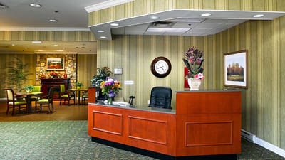 Reception area with floral arrangements and a clock