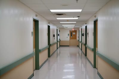 A hallway with doors in a healthcare facility