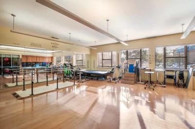 Bright physical therapy room with equipment