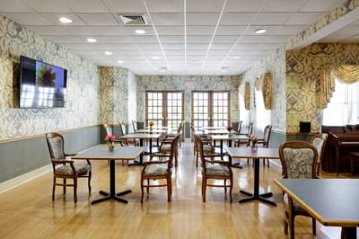 Bright dining room with tables and flowers