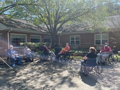 Residents enjoying a sunny outdoor space