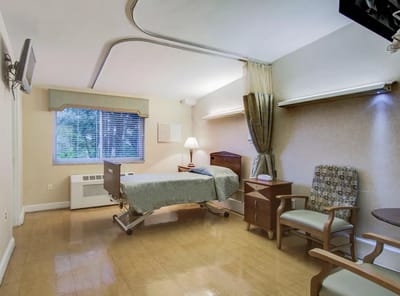 Private resident room with bed and seating area