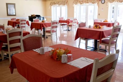 Dining area with red tablecloths and autumn decorations
