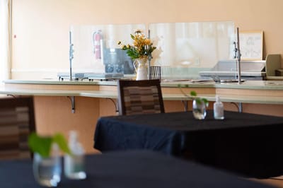 Dining area with tables and a flower arrangement