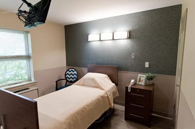Private resident room with bed and furniture