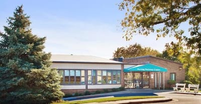 Exterior view of a senior living facility with landscaping