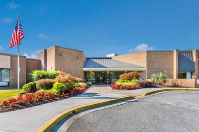 Exterior view of a senior living facility with landscaping