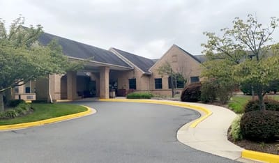 Front entrance of a senior living facility with landscaped grounds