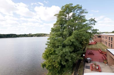 View of a serene waterfront with outdoor seating