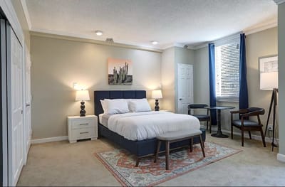Well-furnished private resident room with a bed and decor