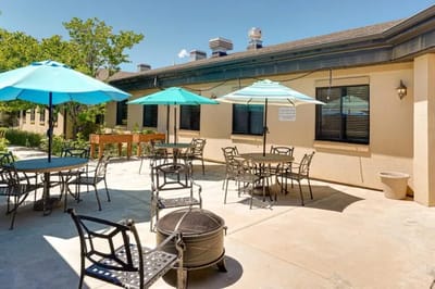 Outdoor patio area with tables and umbrellas