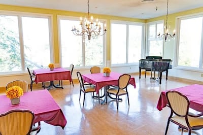 Bright dining room with tables and a piano