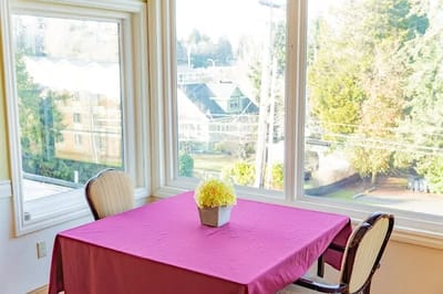 Dining area with a table by large windows