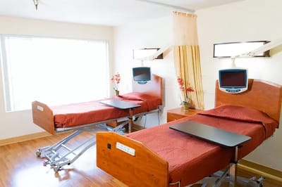 Bright interior of a shared resident room with beds