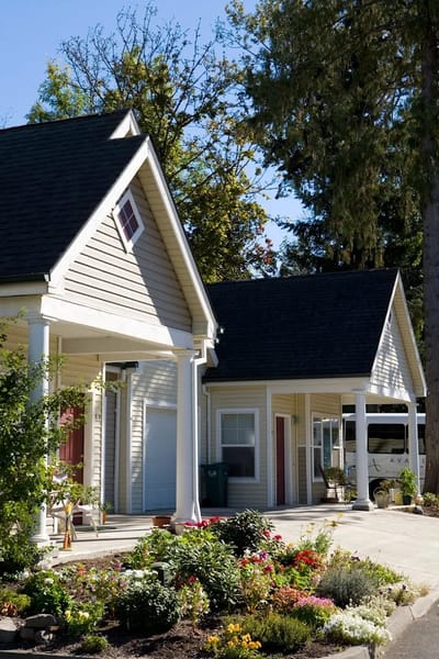 Exterior view of a senior living facility with gardens