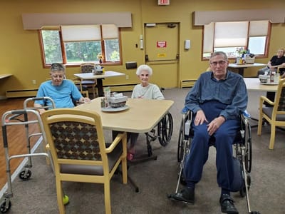 Residents sitting in a bright interior common area